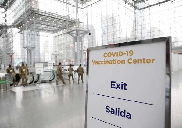 Signs for COVID-19 Vaccintaion are set up around the inside as patients arrive and go through the check in process to received a COVID-19 vaccination at the Jacob K. Javits Convention Center in New York City on Wednesday, January 13, 2021. The Javits Convention Center which served as a massive field hospital last spring when New York City was the epicenter of the pandemic, now will serve as a huge vaccine distribution center.  NYP20210113113 JohnxAngelillo