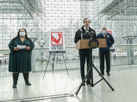 NY: Opening of mass vaccination site at Jacob Javits Center NYS Department of Health Commissioner Dr. Howard Zucker speaks during opening of vaccination site at Jacob Javits Center. To his right is Secretary of State Rossana Rosado and to his left is Director of Emergency Management Michael Kopy. Health care personnel, medical examiners, funeral workers, coroners, essential workers, police officers, firefighters, people older than 65 and more eligible right now to get vaccination in New York State. New York New York United States Copyright: LevxRadin