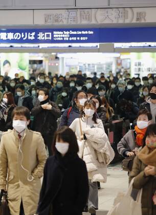 Day after Japan expands coronavirus emergency to 7 more prefectures People wearing face masks pass through Nishitetsu Fukuoka Station on their way to work in Fukuoka, southwestern Japan, on Jan. 14, 2021. Prime Minister Yoshihide Suga declared a state of emergency in seven additional prefectures, including Fukuoka, the previous day amid a recent surge in coronavirus infections.