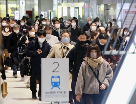 Day after Japan expands coronavirus emergency to 7 more prefectures People wearing face masks pass through Nishitetsu Fukuoka Station on their way to work in Fukuoka, southwestern Japan, on Jan. 14, 2021. Prime Minister Yoshihide Suga declared a state of emergency in seven additional prefectures, including Fukuoka, the previous day amid a recent surge in coronavirus infections.