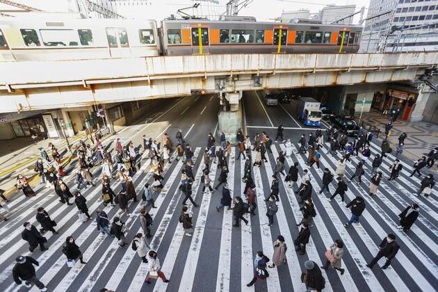 Day after Japan expands coronavirus emergency to 7 more prefectures People wearing face masks walk in Osaka s Umeda area on Jan. 14, 2021. Prime Minister Yoshihide Suga declared a state of emergency in seven additional prefectures, including Osaka, the previous day amid the continued spread of the novel coronavirus. 