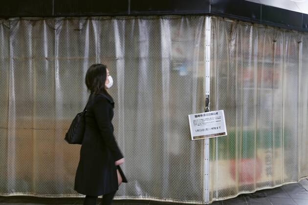 Day after Japan expands coronavirus emergency to 7 more prefectures A woman is seen standing at a deserted food market in Osaka on Jan. 14, 2021, a day after Japanese Prime Minister Yoshihide Suga declared a state of emergency in seven additional prefectures, including Osaka, amid the continued spread of the novel coronavirus.