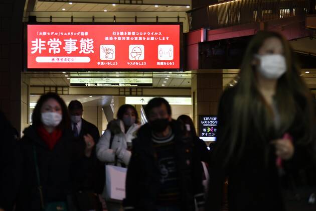 Day after Japan expands coronavirus emergency to 7 more prefectures People wearing face masks walk in Osaka s Umeda area on Jan. 14, 2021, a day after Japanese Prime Minister Yoshihide Suga declared a state of emergency in seven additional prefectures, including Osaka, amid the continued spread of the novel coronavirus. 