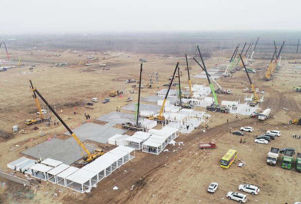 (210114) -- SHIJIAZHUANG, Jan. 14, 2021 -- Aerial photo taken on Jan. 14, 2021 shows the construction site of a centralized medical observation center in Shijiazhuang, capital of north China s Hebei Province. Construction workers on Wednesday started building a centralized medical observation center in Shijiazhuang, capital of north China s Hebei Province, where clustered COVID-19 cases occurred. The isolation center will likely cover 33 hectares of area near a village in Zhengding County, Shijiazhuang. Three integrated housing producers in Tangshan City, Hebei, have been entrusted to produce 3,000 makeshift wards for the center. Each ward has a space of 18 square meters. ) CHINA-HEBEI-SHIJIAZHUANG-COVID-19-ISOLATION CENTER-CONSTRUC