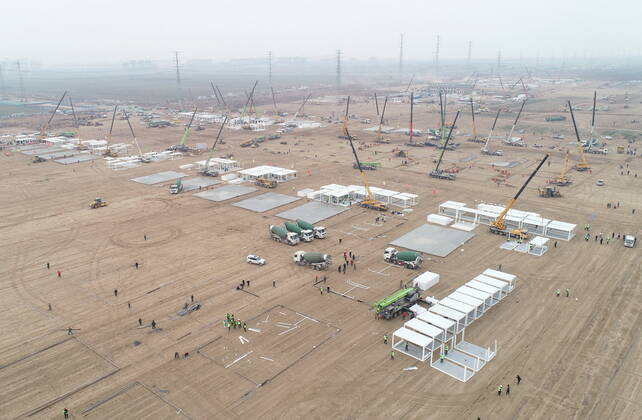 (210114) -- SHIJIAZHUANG, Jan. 14, 2021 -- Aerial photo taken on Jan. 14, 2021 shows the construction site of a centralized medical observation center in Shijiazhuang, capital of north China s Hebei Province. Construction workers on Wednesday started building a centralized medical observation center in Shijiazhuang, capital of north China s Hebei Province, where clustered COVID-19 cases occurred. The isolation center will likely cover 33 hectares of area near a village in Zhengding County, Shijiazhuang. Three integrated housing producers in Tangshan City, Hebei, have been entrusted to produce 3,000 makeshift wards for the center. Each ward has a space of 18 square meters. ) CHINA-HEBEI-SHIJIAZHUANG-COVID-19-ISOLATION CENTER-CONSTRUC