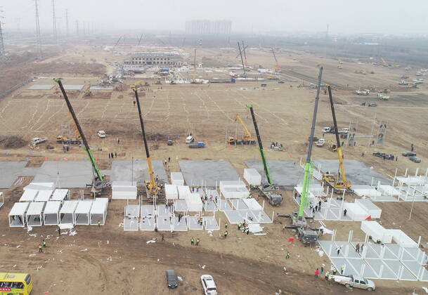 (210114) -- SHIJIAZHUANG, Jan. 14, 2021 -- Aerial photo taken on Jan. 14, 2021 shows the construction site of a centralized medical observation center in Shijiazhuang, capital of north China s Hebei Province. Construction workers on Wednesday started building a centralized medical observation center in Shijiazhuang, capital of north China s Hebei Province, where clustered COVID-19 cases occurred. The isolation center will likely cover 33 hectares of area near a village in Zhengding County, Shijiazhuang. Three integrated housing producers in Tangshan City, Hebei, have been entrusted to produce 3,000 makeshift wards for the center. Each ward has a space of 18 square meters. ) CHINA-HEBEI-SHIJIAZHUANG-COVID-19-ISOLATION CENTER-CONSTRUC