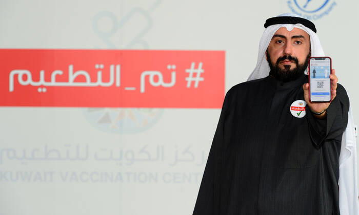(210114) -- HAWALLI GOVERNORATE, Jan. 14, 2021 -- Kuwait s Minister of Health Bassel Al-Sabah shows the COVID-19 vaccine certificate after receiving the second dose of the vaccine in Hawalli Governorate, Kuwait, Jan. 14, 2021. Kuwaiti people started to receive the second doses of COVID-19 vaccine on Thursday, as part of the national vaccination campaign at Kuwait Vaccination Center in Hawalli Governorate. (Photo by Xinhua) KUWAIT-HAWALLI GOVERNORATE-COVID-19-VACCINATION CAMPAIGN-SECOND DOSE Asad 