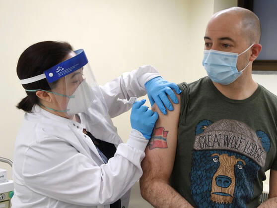 January 14, 2021, Racine, Wisconsin, USA: RN GINA BREHM gives the first of the first 70 doses of 140 doses of the Pfizer COVID-19 vaccine received for City of Racine firefighters as they are administered Thursday January 14, 2021 to FIREFIGHTER WILLIAM WALMSLEY at the city health department in City Hall. The remaining doses will be administered Friday. Racine USA - ZUMAh154 20210114_znp_h154_008 Copyright: xMarkxHertzbergx