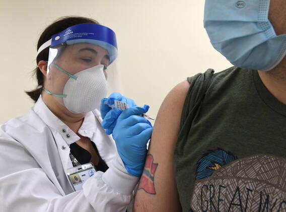 January 14, 2021, Racine, Wisconsin, USA: RN GINA BREHM gives the first of the first 70 doses of 140 doses of the Pfizer COVID-19 vaccine received for City of Racine firefighters as they are administered Thursday January 14, 2021 to FIREFIGHTER WILLIAM WALMSLEY at the city health department in City Hall. The remaining doses will be administered Friday. Racine USA - ZUMAh154 20210114_znp_h154_009 Copyright: xMarkxHertzbergx