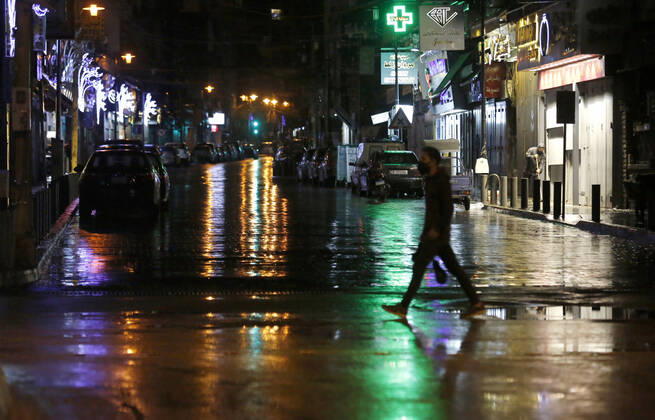 (210114) -- BEIRUT, Jan. 14, 2021 -- A man crosses a street during a lockdown in Beirut, Lebanon, on Jan. 14, 2021. Lebanon s Higher Defense Council declared a state of emergency between Jan. 14-25 that includes a total lockdown in hope to restrict further spread of COVID-19, Al-Jadeed local TV channel reported. ) LEBANON-BEIRUT-COVID-19-LOCKDOWN BilalxJawich 