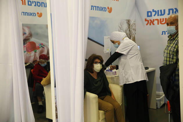 (210114) -- REHOVOT (ISRAEL), Jan. 14, 2021 -- A woman receives a COVID-19 vaccine at a health services center in Rehovot, central Israel, on Jan. 14, 2021. Israel s health ministry reported 10,933 new COVID-19 cases on Thursday, bringing the total number in the country to 528,204. (Photo by Xinhua) ISRAEL-REHOVOT-COVID-19-CASES GilxCohenxMagen 
