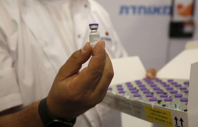 (210114) -- REHOVOT (ISRAEL), Jan. 14, 2021 -- A medical worker shows a vial of the COVID-19 vaccine at a health services center in Rehovot, central Israel, on Jan. 14, 2021. Israel s health ministry reported 10,933 new COVID-19 cases on Thursday, bringing the total number in the country to 528,204. (Photo by Xinhua) ISRAEL-REHOVOT-COVID-19-CASES GilxCohenxMagen 