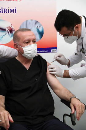 (210114) -- ANKARA, Jan. 14, 2021 () -- Turkish President Recep Tayyip Erdogan (L) receives a dose of COVID-19 vaccine at a hospital in Ankara, Turkey, on Jan. 14, 2021. Erdogan on Thursday received his first dose of vaccine as Turkey has started mass vaccination against COVID-19. () TURKEY-ANKARA-PRESIDENT-COVID-19 VACCINE Xinhua 