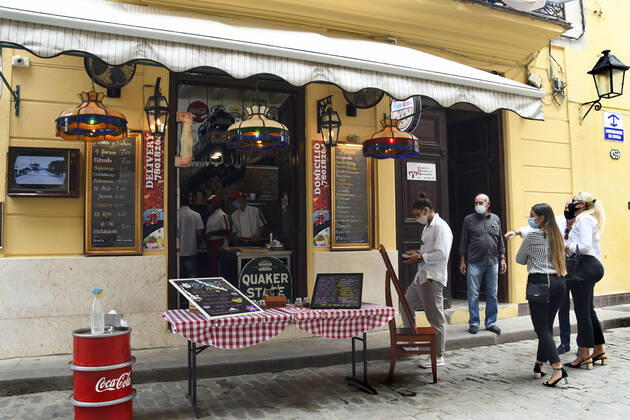 (210115) -- HAVANA, Jan. 15, 2021 -- People wearing face masks wait outside a restaurant in Havana, Cuba, Jan. 14, 2021. Local government in Havana announced new restrictive measures in response to the COVID-19 pandemic as 550 new cases were logged nationwide on Wednesday, setting a new daily record for the sixth day in a row. (Photo by Xinhua) CUBA-HAVANA-COVID-19-CASES JoaquinxHernandez 
