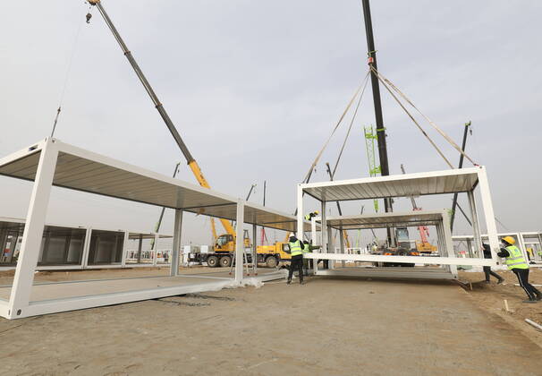 (210115) -- SHIJIAZHUANG, Jan. 15, 2021 (Xinhua) -- People work at the construction site of a centralized medical observation center in Shijiazhuang, capital of north China s Hebei Province, Jan. 15, 2021. As part of the measures to cope with the recent COVID-19 resurgence, authorities in Shijiazhuang have rushed to build a new isolation center with a designed capacity of 3,000 rooms in Zhengding County. Close contacts and sub-close contacts of confirmed COVID-19 patients will be placed under medical observation in the new center, which will cover a total area of about 33.3 hectares, according to the housing and urban-rural development bureau of Shijiazhuang. With an area of 18 square meters, each room will be equipped with facilities - ZUMAHIJI XxjpbeE007300_20210115_PEPFN0A001 Copyright: xYangxShiyaox