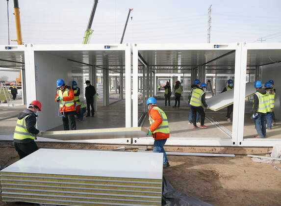 (210115) -- SHIJIAZHUANG, Jan. 15, 2021 (Xinhua) -- People work at the construction site of a centralized medical observation center in Shijiazhuang, capital of north China s Hebei Province, Jan. 15, 2021. As part of the measures to cope with the recent COVID-19 resurgence, authorities in Shijiazhuang have rushed to build a new isolation center with a designed capacity of 3,000 rooms in Zhengding County. Close contacts and sub-close contacts of confirmed COVID-19 patients will be placed under medical observation in the new center, which will cover a total area of about 33.3 hectares, according to the housing and urban-rural development bureau of Shijiazhuang. With an area of 18 square meters, each room will be equipped with facilities - ZUMAHIJI XxjpbeE007304_20210115_PEPFN0A001 Copyright: xYangxShiyaox