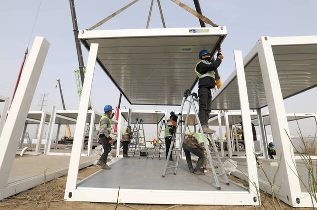 (210115) -- SHIJIAZHUANG, Jan. 15, 2021 (Xinhua) -- People work at the construction site of a centralized medical observation center in Shijiazhuang, capital of north China s Hebei Province, Jan. 15, 2021. As part of the measures to cope with the recent COVID-19 resurgence, authorities in Shijiazhuang have rushed to build a new isolation center with a designed capacity of 3,000 rooms in Zhengding County. Close contacts and sub-close contacts of confirmed COVID-19 patients will be placed under medical observation in the new center, which will cover a total area of about 33.3 hectares, according to the housing and urban-rural development bureau of Shijiazhuang. With an area of 18 square meters, each room will be equipped with facilities - ZUMAHIJI XxjpbeE007307_20210115_PEPFN0A001 Copyright: xYangxShiyaox