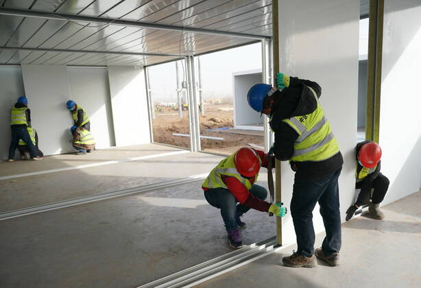 (210115) -- SHIJIAZHUANG, Jan. 15, 2021 (Xinhua) -- People work at the construction site of a centralized medical observation center in Shijiazhuang, capital of north China s Hebei Province, Jan. 15, 2021. As part of the measures to cope with the recent COVID-19 resurgence, authorities in Shijiazhuang have rushed to build a new isolation center with a designed capacity of 3,000 rooms in Zhengding County. Close contacts and sub-close contacts of confirmed COVID-19 patients will be placed under medical observation in the new center, which will cover a total area of about 33.3 hectares, according to the housing and urban-rural development bureau of Shijiazhuang. With an area of 18 square meters, each room will be equipped with facilities - ZUMAHIJI XxjpbeE007308_20210115_PEPFN0A001 Copyright: xYangxShiyaox