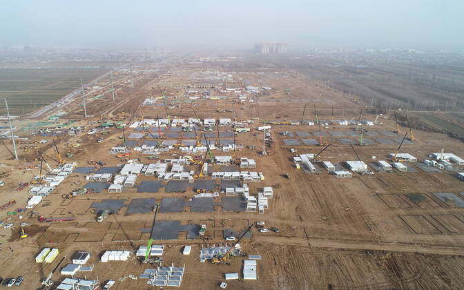 (210115) -- SHIJIAZHUANG, Jan. 15, 2021 (Xinhua) -- Aerial photo taken on Jan. 15, 2021 shows the construction site of a centralized medical observation center in Shijiazhuang, capital of north China s Hebei Province. As part of the measures to cope with the recent COVID-19 resurgence, authorities in Shijiazhuang have rushed to build a new isolation center with a designed capacity of 3,000 rooms in Zhengding County. Close contacts and sub-close contacts of confirmed COVID-19 patients will be placed under medical observation in the new center, which will cover a total area of about 33.3 hectares, according to the housing and urban-rural development bureau of Shijiazhuang. With an area of 18 square meters, each room will be equipped wit  - ZUMAHIJI XxjpbeE007310_20210115_PEPFN0A001 Copyright: xYangxShiyaox