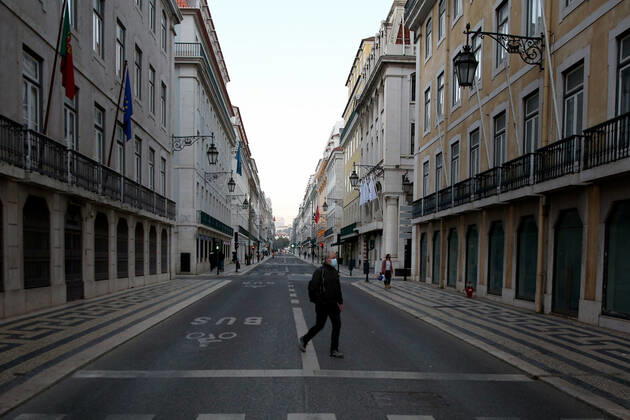 January 15, 2021, Lisbon, Portugal: A man wearing a face mask crosses a street in Lisbon, Portugal on January 15, 2021, on the first day of the second national lockdown to combat the COVID-19 Coronavirus pandemic. Portuguese Prime Minister Antonio Costa announced last Wednesday a new confinement between January 15 and 30 with the same restrictive measures of March and April 2020, with the only relevant new exception that is schools will remain in full operation. Lisbon Portugal - ZUMAf123 20210115_zap_f123_015 Copyright: xPedroxFiuzax