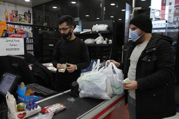 (210115) -- TRIPOLI (LEBANON), Jan. 15, 2021 -- A delivery worker packs items for delivery during a total lockdown in Tripoli, Lebanon, on Jan. 15, 2021. Lebanon registered on Friday 6,154 new COVID-19 cases, the highest daily increase in the country, raising the tally to 243,286, the Health Ministry reported. The death toll from the virus went up by 44 to 1,825, it added. (Photo by Xinhua) LEBANON-TRIPOLI-COVID-19-CASES Khaled