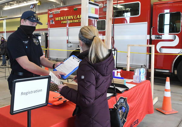 January 15, 2021, Oconomowoc, Wisconsin, USA: 119 firefighters and other front-line health profession workers were vaccinated against the Coronavirus with the Pfizer vaccine Friday January 15, 2021 at the Western Lakes Fire Department headquarters in Oconomowoc, Wisconsin, bringing the weekÃ¢â‚¬â ¢s total to 798. The rural fire department has six stations serving about 200 sq. miles. JUSTIN LEARNED took temperatures and registered people when they arrived at the clinic. Oconomowoc USA - ZUMAh154 20210115_znp_h154_025 Copyright: xMarkxHertzbergx