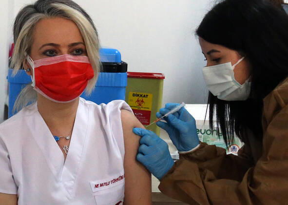 (210116) -- ANKARA, Jan. 16, 2021 -- A medical worker receives a dose of China s Sinovac COVID-19 vaccine at the Sabiha Uzun Maternal Child Health Center in Ankara, Turkey on Jan. 15, 2021. More than 600,000 health workers in Turkey have received their first doses of COVID-19 shots developed by China s Sinovac during the first two days of the country s vaccination program, Turkish Health Ministry s data showed on Friday. (Photo by Xinhua) TURKEY-ANKARA-HEALTH WORKER-COVID-19-VACCINATION MustafaxKaya 