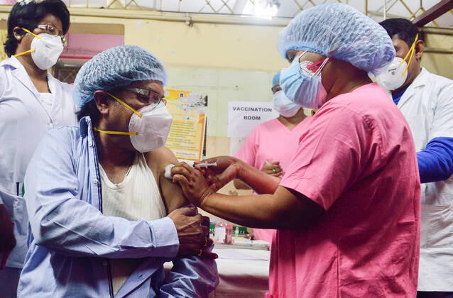 January 16, 2021, Kolkata, West Bengal, India: A nurse vaccinate a frontline health worker with Covishield Coronavirus vaccine developed by Oxford University and AstraZeneca Plc and Produced by Serum Institute Of India at the M.R. Bangur Hospital..India started its First Phase of Coronavirus (Covid-19) vaccination today. Kolkata India - ZUMAs197 20210116_zaa_s197_019 Copyright: xSumitxSanyalx