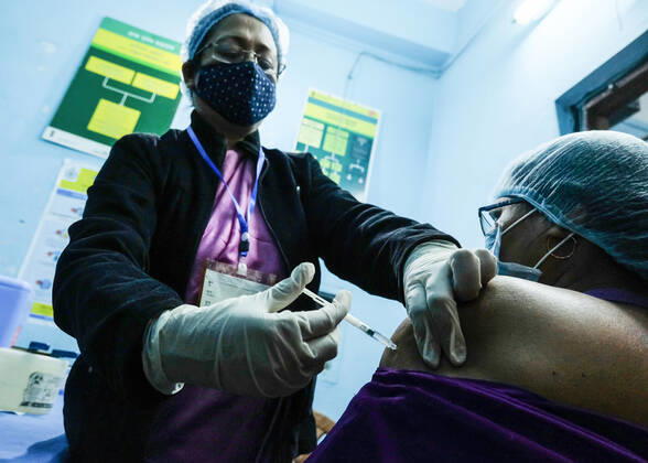 January 16, 2021, Kolkata, West Bengal, India: A nurse vaccinate a frontline health worker with Covishield Coronavirus vaccine developed by Oxford University and AstraZeneca Plc and Produced by Serum Institute Of India, at the Madhyamgram Hospital. After a year since the coronavirus pandemic began, claiming over 150.000 lives in India, Prime Minister Narendra Modi launched a nationwide vaccination drive against Covid-19, today. Kolkata India - ZUMAs197 20210116_zaa_s197_047 Copyright: xDipayanxBosex