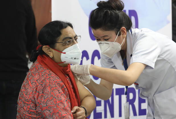 January 16, 2021, New Delhi, India: A nurse seen vaccinating a front line medical worker at the All India Institute of Medical Science..The nationwide Covid-19 vaccination program began today in India. Frontline health workers are the first group of people to be vaccinated. New Delhi India - ZUMAs197 20210116_zaa_s197_099 Copyright: xNaveenxSharmax