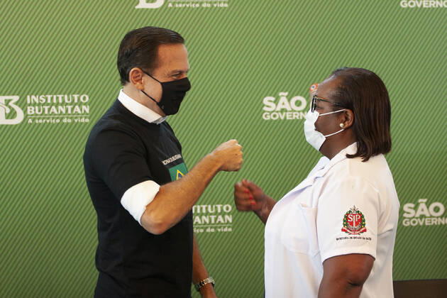 First COVID-19 Vaccination in Sao Paulo Brazil. First COVID-19 Vaccination in Sao Paulo Brazil. January 17, 2021, Sao Paulo, Brazil: The Governor of Sao Paulo, Joao Doria speaks during a press conference at Hospital das Clinicas - HCFMUSP, at the end of Anvisa s vote of approval on the emergency use of Butantan COVID-19 Vaccine and the first Brazilian to be vaccinated is a nurse called Monica Calazans, 54 years old, resident of Itaquera and who works on the front line against Covid-19 at the Instituto de Infectologia Emilio Ribas. She was vaccinated by Jessica Pires de Camargo, 30 years old, disease control nurse and Master of Public Health at Santa Casa de Sao Paulo. First COVID-19 Vaccination in Sao Paulo Brazil.  Copyright: xLecoxVianax