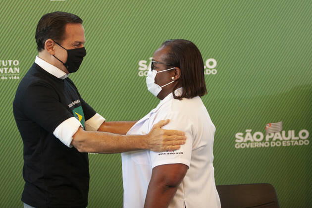 First COVID-19 Vaccination in Sao Paulo Brazil. First COVID-19 Vaccination in Sao Paulo Brazil. January 17, 2021, Sao Paulo, Brazil: The Governor of Sao Paulo, Joao Doria speaks during a press conference at Hospital das Clinicas - HCFMUSP, at the end of Anvisa s vote of approval on the emergency use of Butantan COVID-19 Vaccine and the first Brazilian to be vaccinated is a nurse called Monica Calazans, 54 years old, resident of Itaquera and who works on the front line against Covid-19 at the Instituto de Infectologia Emilio Ribas. She was vaccinated by Jessica Pires de Camargo, 30 years old, disease control nurse and Master of Public Health at Santa Casa de Sao Paulo. First COVID-19 Vaccination in Sao Paulo Brazil.  Copyright: xLecoxVianax