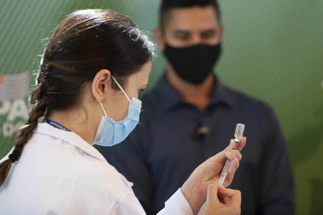 First COVID-19 Vaccination in Sao Paulo Brazil. First COVID-19 Vaccination in Sao Paulo Brazil. January 17, 2021, Sao Paulo, Brazil: The Governor of Sao Paulo, Joao Doria speaks during a press conference at Hospital das Clinicas - HCFMUSP, at the end of Anvisa s vote of approval on the emergency use of Butantan COVID-19 Vaccine and the first Brazilian to be vaccinated is a nurse called Monica Calazans, 54 years old, resident of Itaquera and who works on the front line against Covid-19 at the Instituto de Infectologia Emilio Ribas. She was vaccinated by Jessica Pires de Camargo, 30 years old, disease control nurse and Master of Public Health at Santa Casa de Sao Paulo. First COVID-19 Vaccination in Sao Paulo Brazil.  Copyright: xLecoxVianax