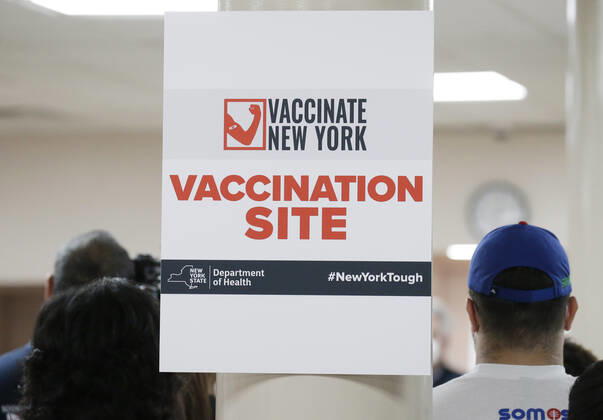 Attendees listen to remarks when Ruth Hassell-Thompson, Special Advisor for Policy and Community Affairs, NYS Homes and Community Renewal, and Reverend Dr. Calvin Butts open a New York State coronavirus vaccination site in Harlem at Abyssinian Baptist Church in New York City on Sunday, January 17, 2021.  NYP20210117140 JohnxAngelillo