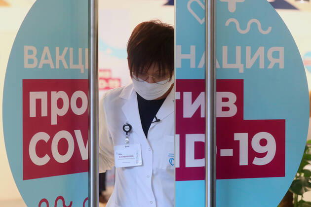 MOSCOW, RUSSIA - JANUARY 18, 2021: A medical worker stands in the doorway of a mobile COVID-19 vaccination unit at the GUM department store. Alexander Shcherbak TASS  TS0F47AF