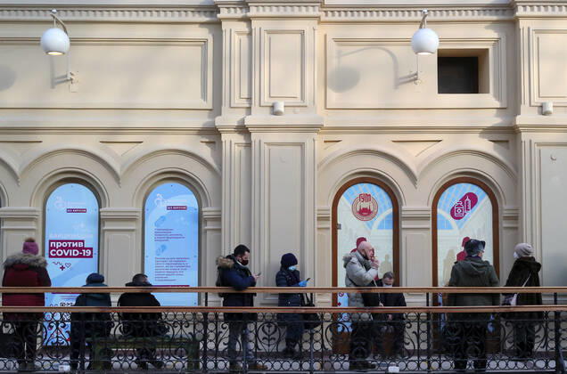 MOSCOW, RUSSIA - JANUARY 18, 2021: Citizens queue outside a mobile COVID-19 vaccination unit at the GUM department store. Alexander Shcherbak TASS  TS0F47D8