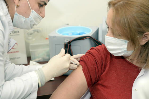 (210118) -- BAKU, Jan. 18, 2021 -- A medical worker receives a dose of China s Sinovac COVID-19 vaccine at a hospital in Baku, Azerbaijan, Jan. 18, 2021. Azerbaijan s senior health officials on Monday took their first inoculations of a vaccine made by Chinese biopharmaceutical company Sinovac Biotech, marking the beginning of mass vaccination against COVID-19 in the country, according to state-run news agency AZERTAC. (Photo by Xinhua) AZERBAIJAN-BAKU-HEALTH WORKER-COVID-19-VACCINATION TofikxBabayev 