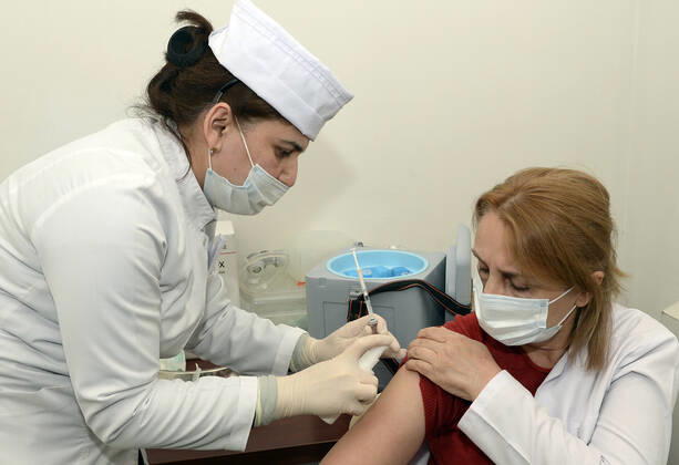 (210118) -- BAKU, Jan. 18, 2021 -- A medical worker receives a dose of China s Sinovac COVID-19 vaccine at a hospital in Baku, Azerbaijan, Jan. 18, 2021. Azerbaijan s senior health officials on Monday took their first inoculations of a vaccine made by Chinese biopharmaceutical company Sinovac Biotech, marking the beginning of mass vaccination against COVID-19 in the country, according to state-run news agency AZERTAC. (Photo by Xinhua) AZERBAIJAN-BAKU-HEALTH WORKER-COVID-19-VACCINATION TofikxBabayev 