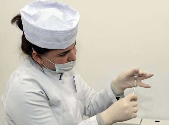(210118) -- BAKU, Jan. 18, 2021 -- A medical worker prepares a dose of China s Sinovac COVID-19 vaccine at a hospital in Baku, Azerbaijan, Jan. 18, 2021. Azerbaijan s senior health officials on Monday took their first inoculations of a vaccine made by Chinese biopharmaceutical company Sinovac Biotech, marking the beginning of mass vaccination against COVID-19 in the country, according to state-run news agency AZERTAC. (Photo by Xinhua) AZERBAIJAN-BAKU-HEALTH WORKER-COVID-19-VACCINATION TofikxBabayev 