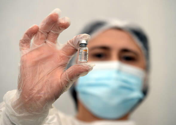 (210118) -- BAKU, Jan. 18, 2021 -- A medical worker displays China s Sinovac COVID-19 vaccine before the vaccination at a hospital in Baku, Azerbaijan, Jan. 18, 2021. Azerbaijan s senior health officials on Monday took their first inoculations of a vaccine made by Chinese biopharmaceutical company Sinovac Biotech, marking the beginning of mass vaccination against COVID-19 in the country, according to state-run news agency AZERTAC. (Photo by Xinhua) AZERBAIJAN-BAKU-HEALTH WORKER-COVID-19-VACCINATION TofikxBabayev 