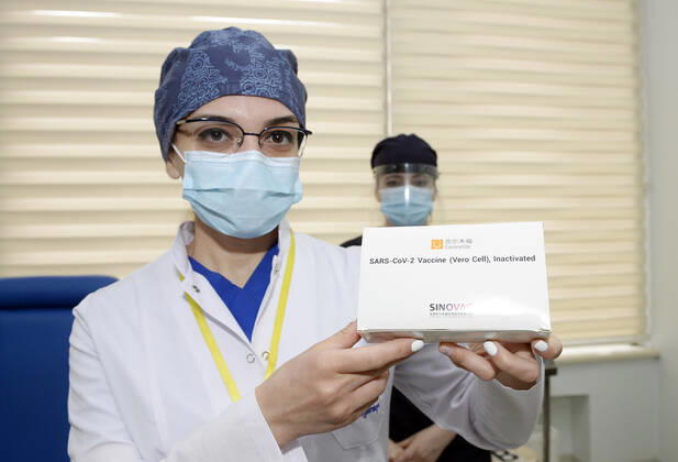 (210118) -- BAKU, Jan. 18, 2021 -- A medical worker displays China s Sinovac COVID-19 vaccine before the vaccination at a hospital in Baku, Azerbaijan, Jan. 18, 2021. Azerbaijan s senior health officials on Monday took their first inoculations of a vaccine made by Chinese biopharmaceutical company Sinovac Biotech, marking the beginning of mass vaccination against COVID-19 in the country, according to state-run news agency AZERTAC. (Photo by Xinhua) AZERBAIJAN-BAKU-HEALTH WORKER-COVID-19-VACCINATION TofikxBabayev 