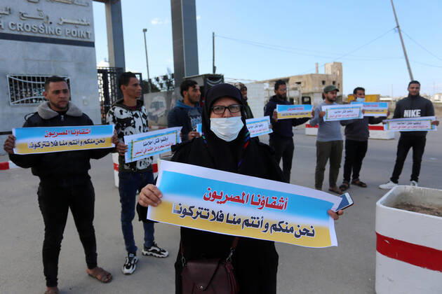 January 18, 2021, Rafah, Gaza Strip, Palestinian Territory: Palestinian protesters hold banners demanding for opening of the Rafah crossing for patients and students, in front of the Rafah border crossing, in Rafah in the southern of Gaza Strip, on January 18, 2021 Rafah Palestinian Territory - ZUMAap3_ 20210118_zaf_ap3_049 Copyright: xAshrafxAmrax