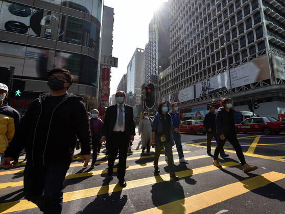 (210118) -- HONG KONG, Jan. 18, 2021 -- People wearing face masks walk on the street in south China s Hong Kong, Jan. 18, 2021. Hong Kong s Center for Health Protection (CHP) reported 107 additional confirmed cases of COVID-19 on Monday, a new high in about one month. The new cases included 102 local infections and five imported ones, taking its total tally to 9,664. More than 40 of the new local cases were untraceable and there were about 50 cases tested positive preliminarily, according to a CHP press briefing. ) CHINA-HONG KONG-COVID-19(CN) LoxPingxFai