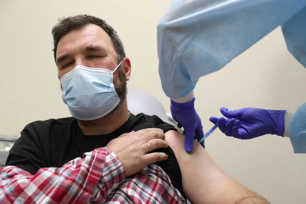 MOSCOW, RUSSIA - JANUARY 18, 2021: A man is vaccinated with Gam-COVID-Vac (Sputnik V), a COVID-19 vaccine, at a private clinic of the Medsi chain. Sergei Savostyanov TASS  TS0F4865