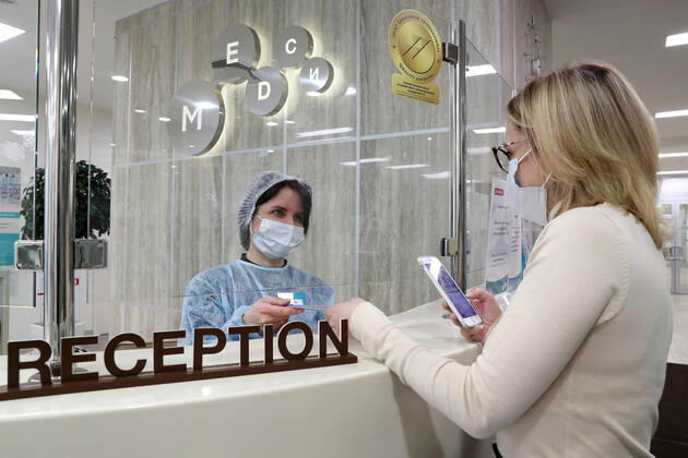 MOSCOW, RUSSIA - JANUARY 18, 2021: A patient is seen by a reception desk of a private clinic of the Medsi chain where people can receive Gam-COVID-Vac (Sputnik V), a COVID-19 vaccine. Sergei Savostyanov TASS  TS0F4868