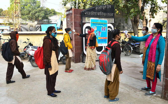 India: Schools reopened after 10 months in Rajasthan Students undergo thermal screening as they arrive to attend classes at a government school that was reopened after remaining closed for 309 days due to COVID-19 pandemic in Beawar. Beawar Rajasthan India Copyright: SumitxSaraswat