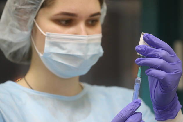 MOSCOW, RUSSIA - JANUARY 18, 2021: A nurse fills a syringe with Gam-COVID-Vac (Sputnik V), a COVID-19 vaccine, at a private clinic of the Medsi chain. Sergei Savostyanov TASS  TS0F486D