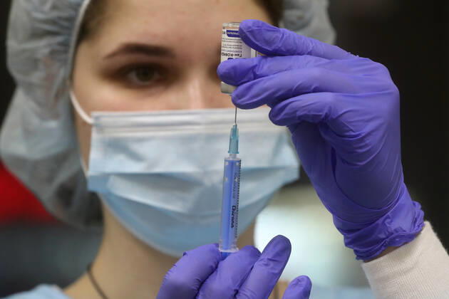 MOSCOW, RUSSIA - JANUARY 18, 2021: A nurse fills a syringe with Gam-COVID-Vac (Sputnik V), a COVID-19 vaccine, at a private clinic of the Medsi chain. Sergei Savostyanov TASS  TS0F4877