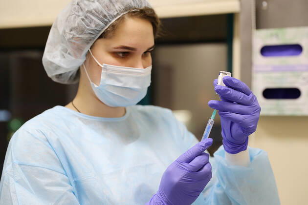 MOSCOW, RUSSIA - JANUARY 18, 2021: A nurse fills a syringe with Gam-COVID-Vac (Sputnik V), a COVID-19 vaccine, at a private clinic of the Medsi chain. Sergei Savostyanov TASS  TS0F4882