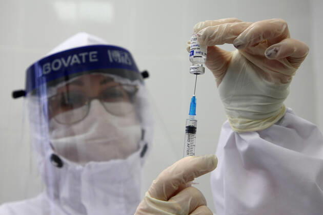 VOLGOGRAD, RUSSIA - JANUARY 18, 2021: A nurse fills a syringe with Gam-COVID-Vac (Sputnik V), a COVID-19 vaccine, at the Volgograd nursing home for the elderly and disables. Dmitry Rogulin TASS  TS0F489D